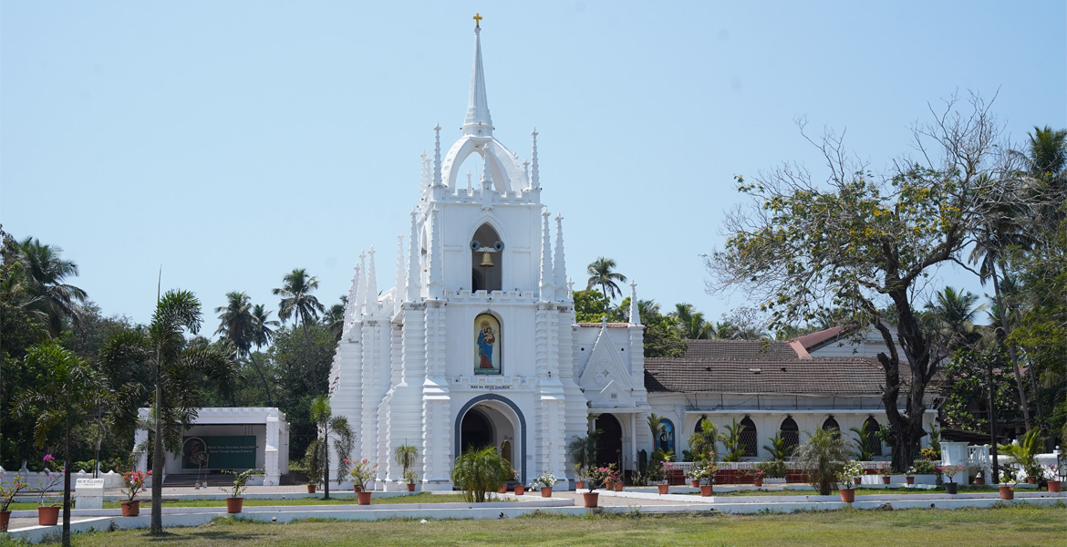 Mae De Deus Church in Saligao, Goa featuring striking white Neo-Gothic architecture and a tall central spire