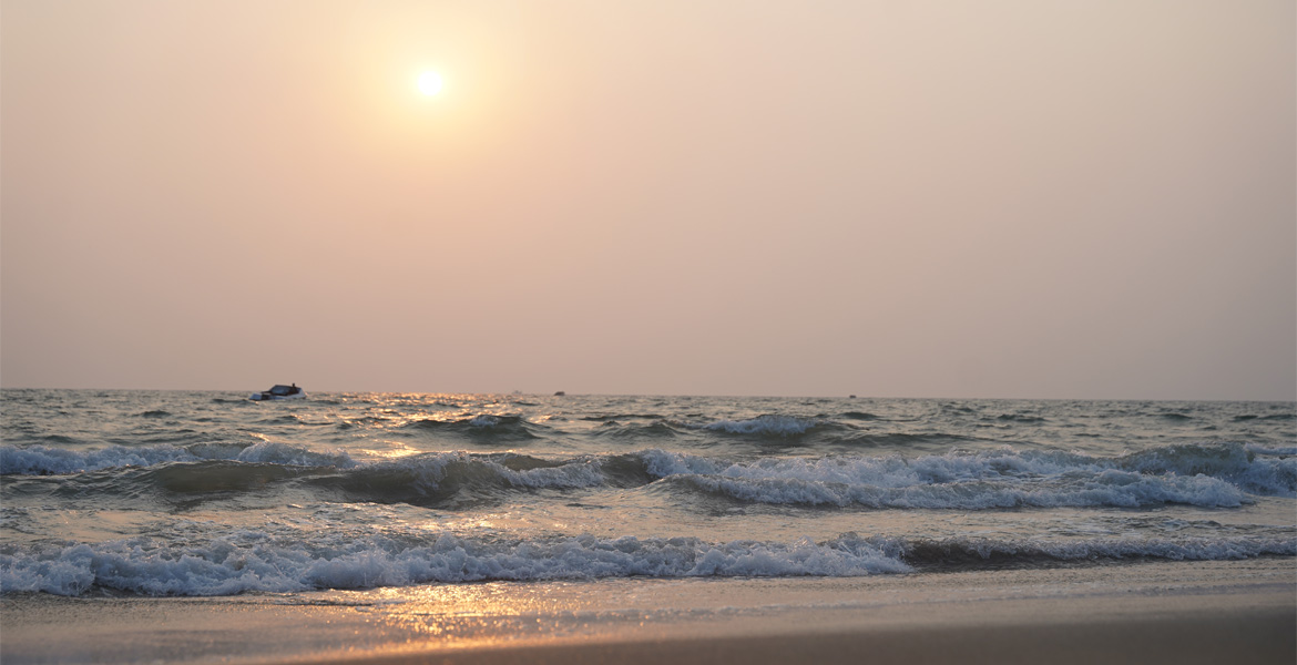 Golden sunset over the Arabian Sea at Majorda Beach Goa with gentle waves along the shoreline