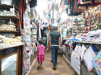 Visitors walking through the busy Margao Municipal Market with local shops and stalls in Goa