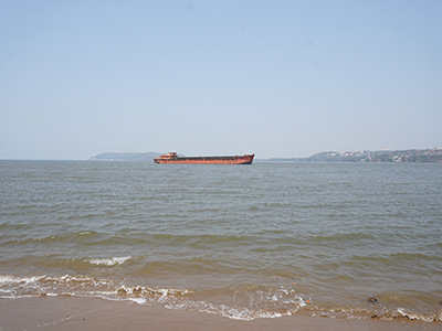 Cargo ship sailing across the Arabian Sea as seen from Miramar Beach in Panaji, Goa