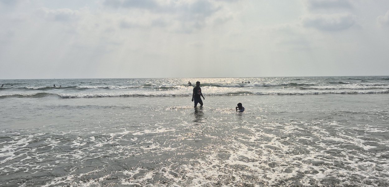 Morjim Beach Goa with people in the sea