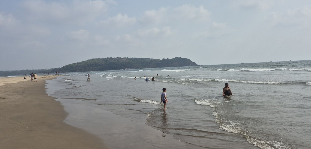 Morjim Beach Goa shoreline with hills