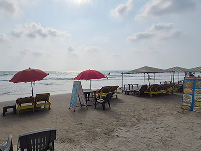 Beach seating and umbrellas at Morjim Beach, Goa