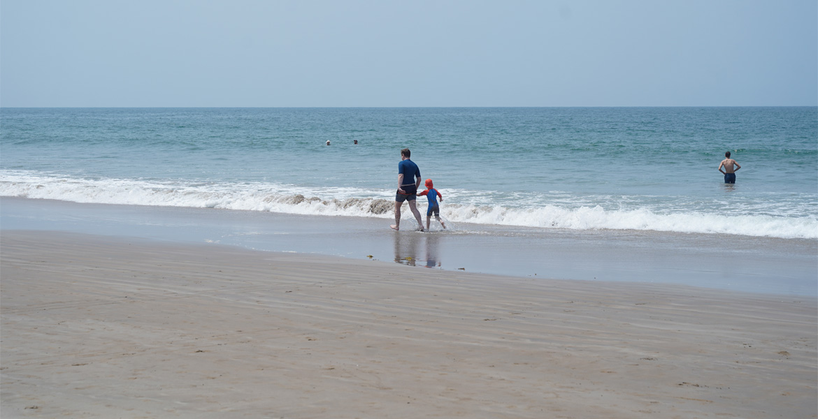 Family walking along Patnem Beach, Goa