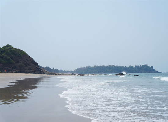 Waves along the rocky coastline at Patnem Beach, Goa
