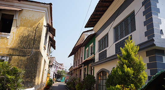 Colorful Portuguese-style houses and narrow street view in Goa