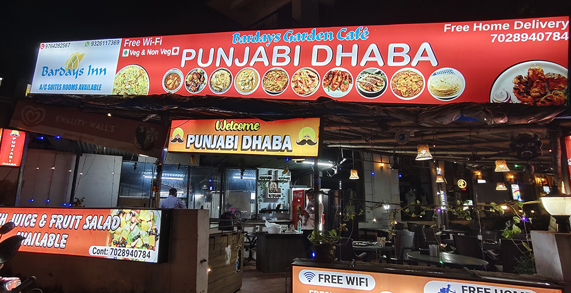 Punjabi Dhaba restaurant and outdoor dining area in Goa at night.