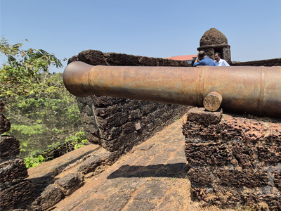 Historic cannon at Reis Magos Fort overlooking the surrounding landscape in Goa