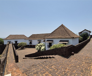 Historic buildings and stone pathways inside Reis Magos Fort showcasing Portuguese architecture in Goa