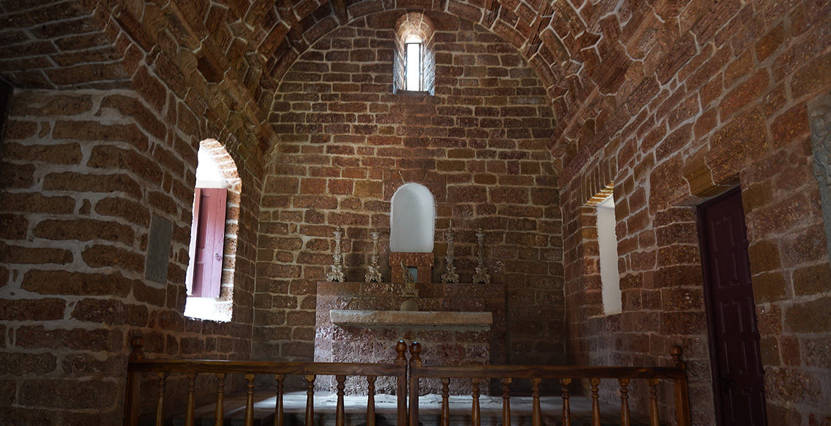Historic stone chapel interior inside Se Cathedral in Old Goa with arched ceiling and altar