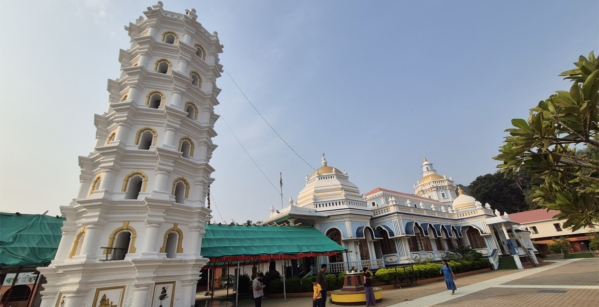 Deepastambha (lamp tower) and Shri Mangeshi Temple in Priol, Goa showcasing traditional Hindu temple architecture