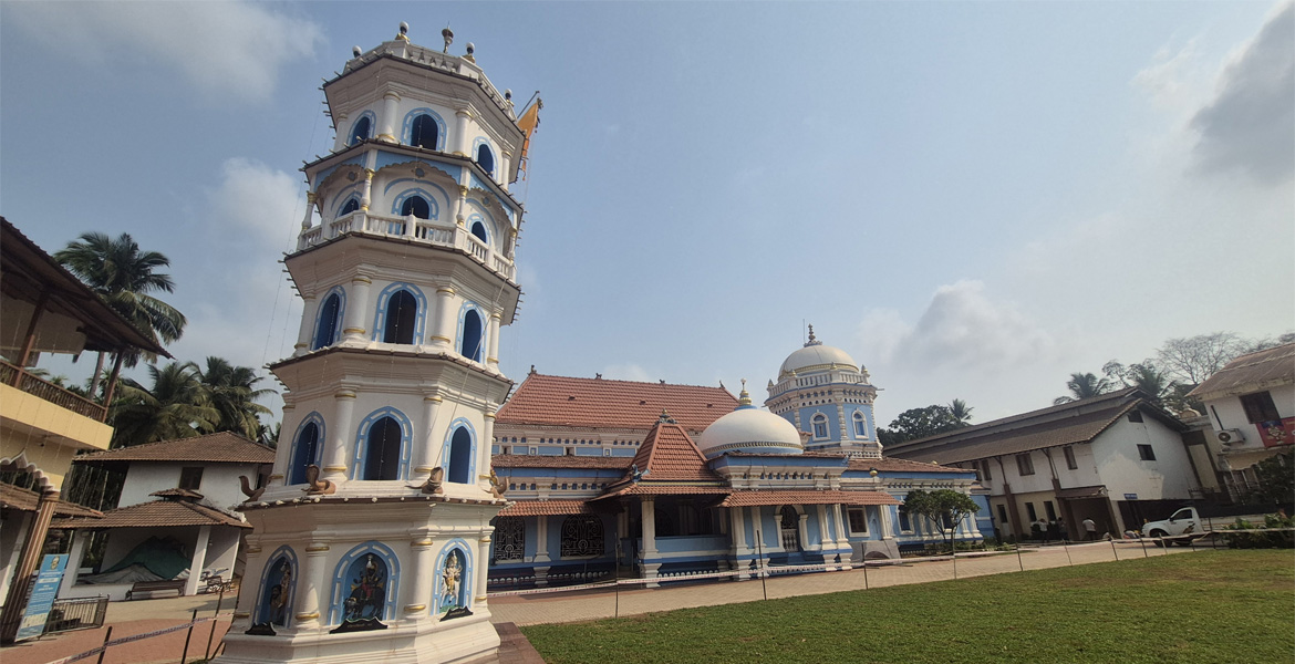 Deepastambha (lamp tower) and Shri Nageshi Temple in Bandora, Goa showcasing traditional Hindu temple architecture