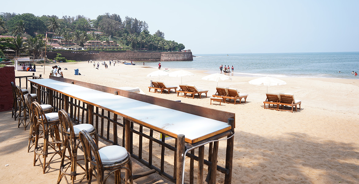 Beachfront restaurant seating overlooking Sinquerim Beach in Goa