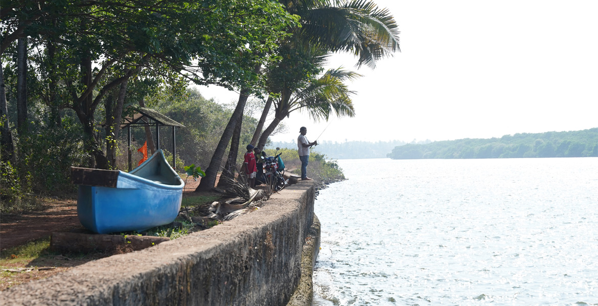 Fishing by the waterfront in Siolim, Goa
