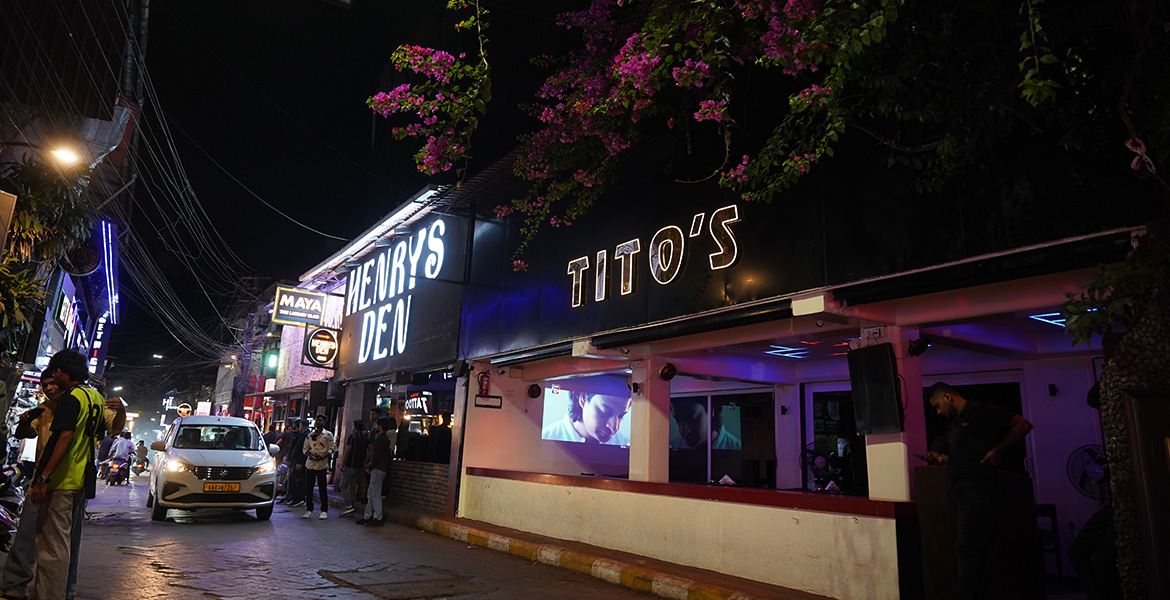 Nightlife street view near Tito's Lane featuring clubs, neon lights, restaurants, and evening crowd in Goa
