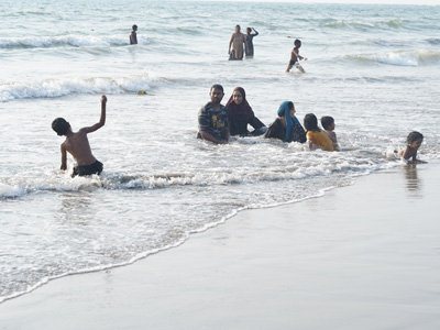 Families and children enjoying the sea waves at Vagator Beach in Goa