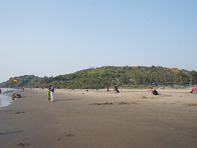 View of Vagator Beach from Chapora Fort in Goa with sandy shoreline and hill backdrop