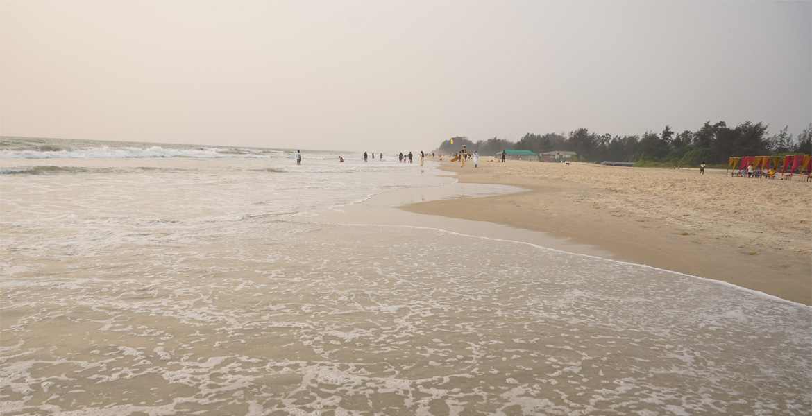Gentle waves along the sandy shoreline of Varca Beach, Goa