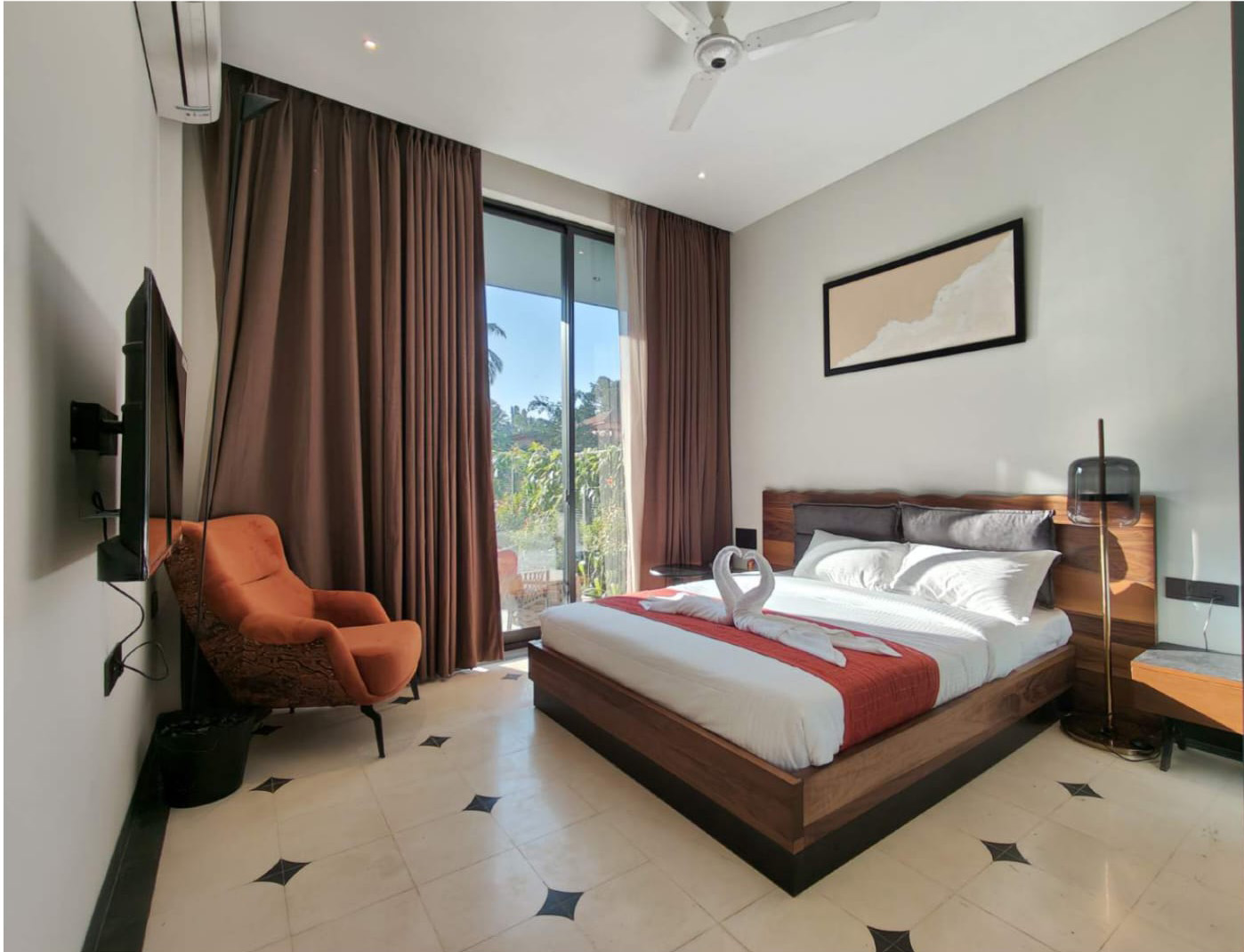 Bedroom with direct outdoor access, white ceiling fan, and a bed with swan towel art.