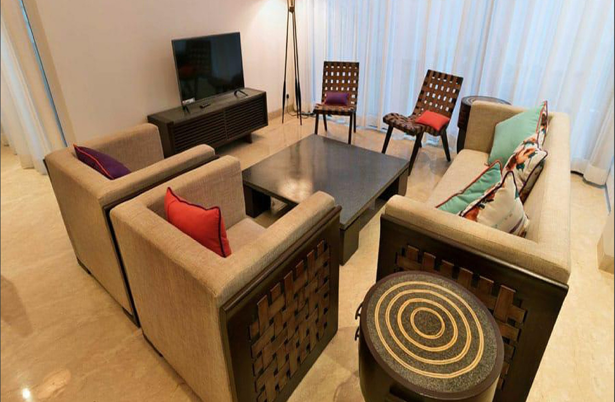 Modern living room with neutral sofas and colorful cushions