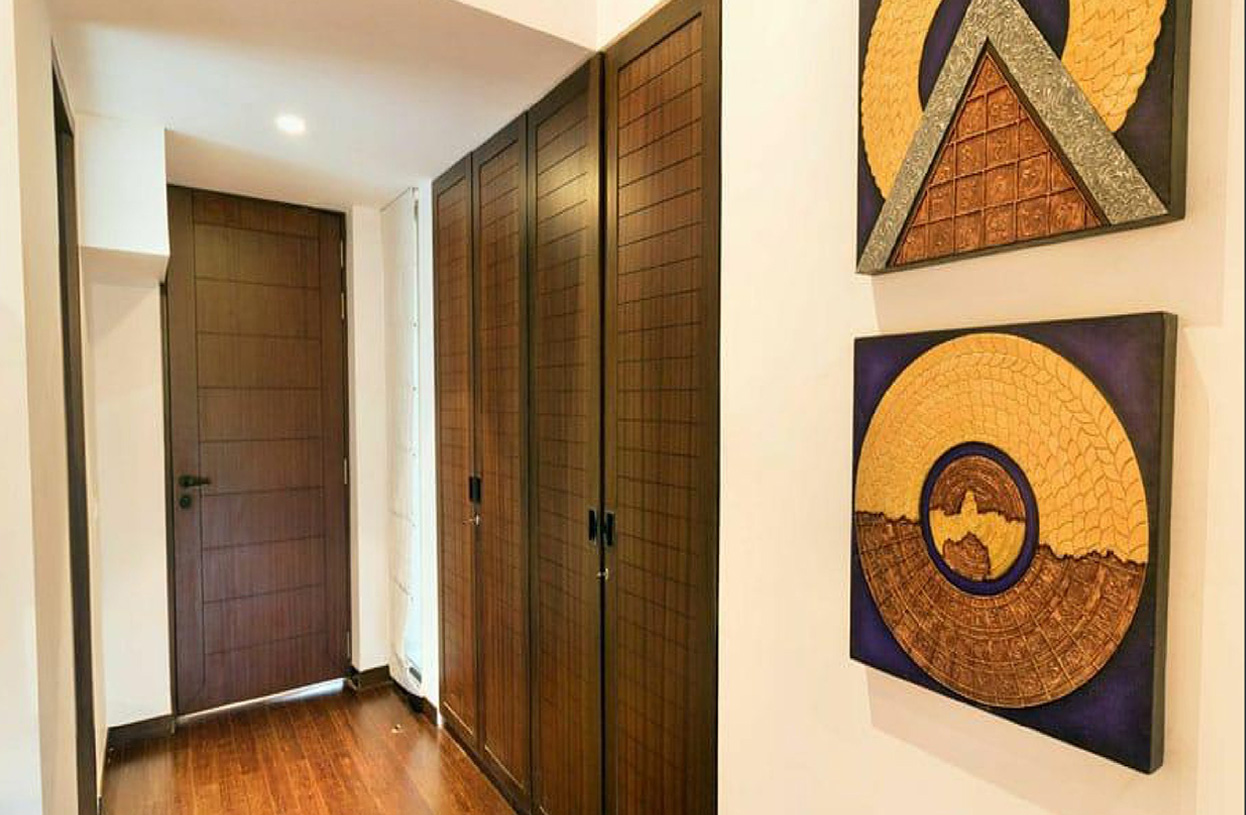 Hallway with wooden wardrobes and decorative wall art