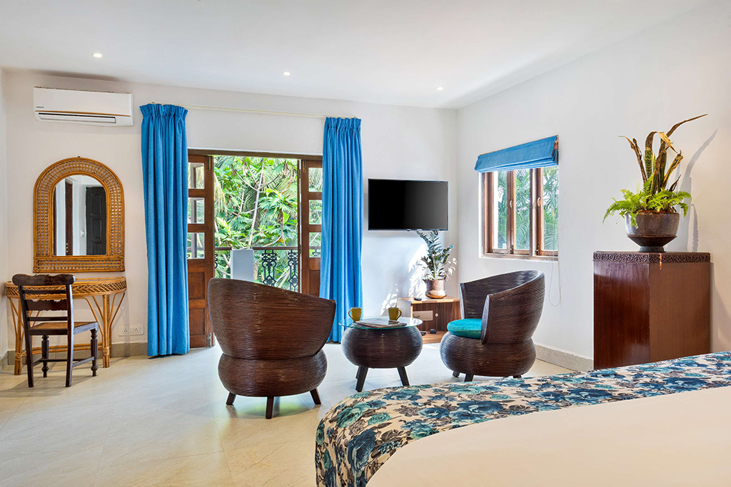 Wicker seating area in a bright room with blue curtains