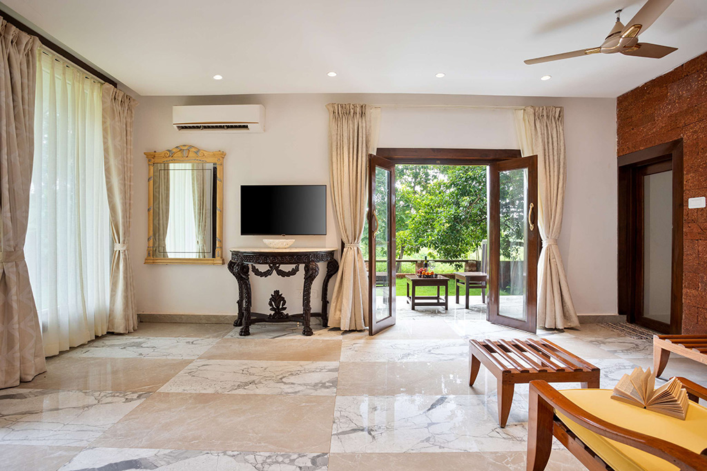 Bright living space with large windows, marble floor, TV, and views of the outdoors