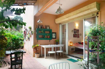 Cozy villa patio with outdoor seating and garden view