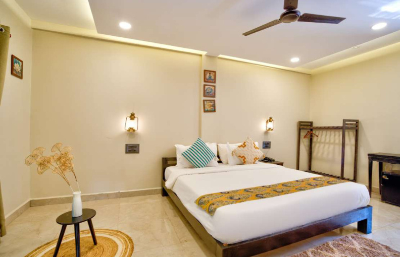 Deluxe bedroom with stylish decor and seating area