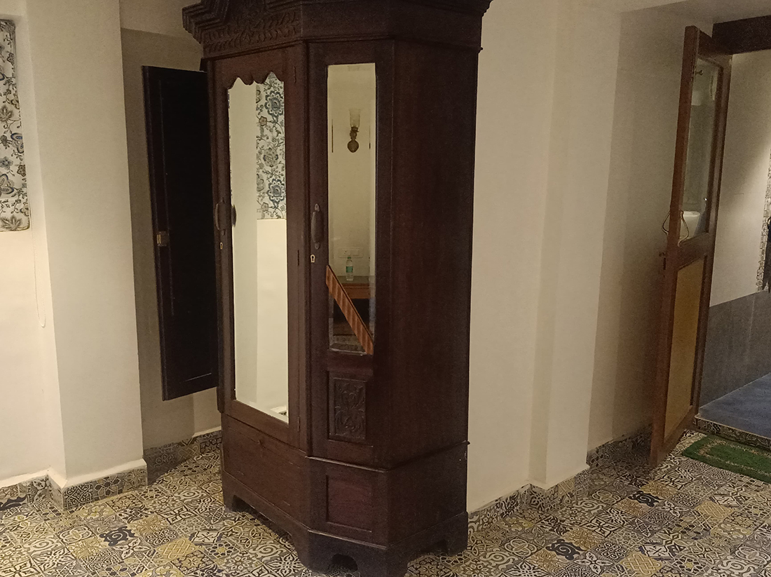 Antique wooden wardrobe with mirrored doors