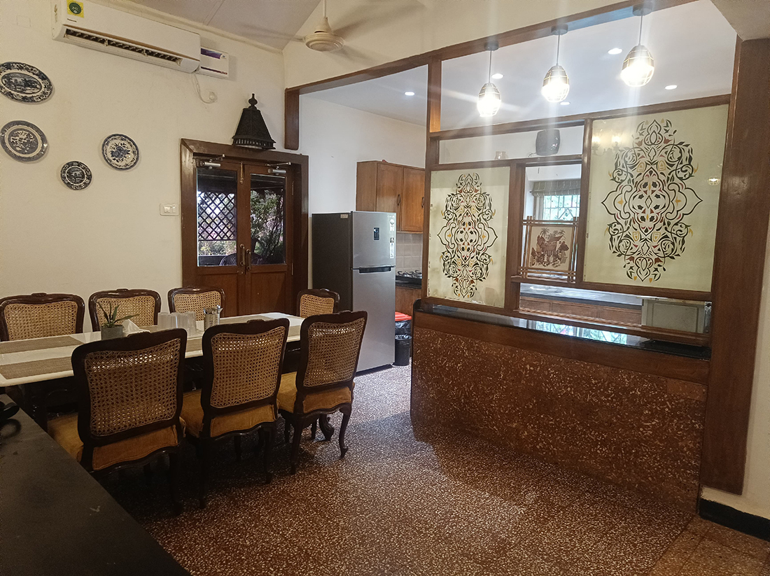 Dining area with a view into the kitchen and refrigerator.