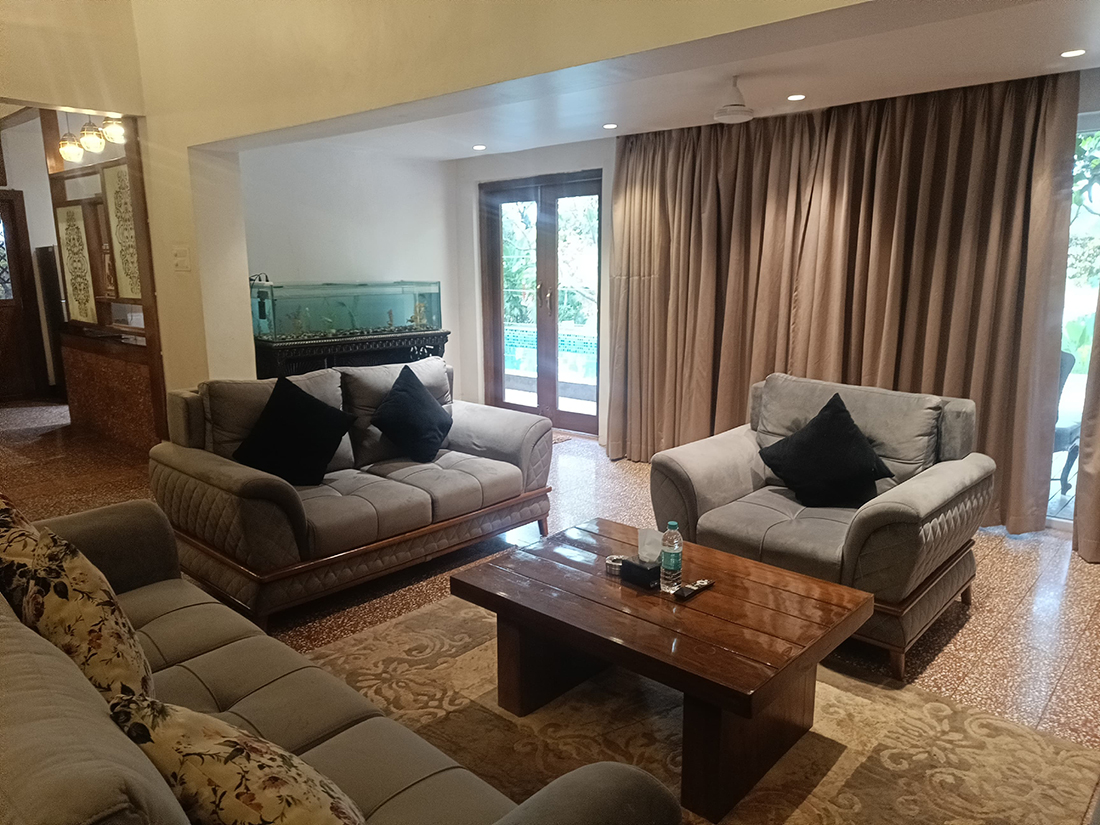 Living room with sofas, aquarium, and garden access