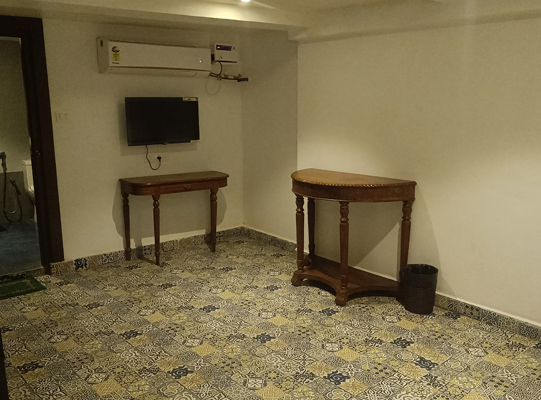 Bedroom with TV, entry to a large bathroom