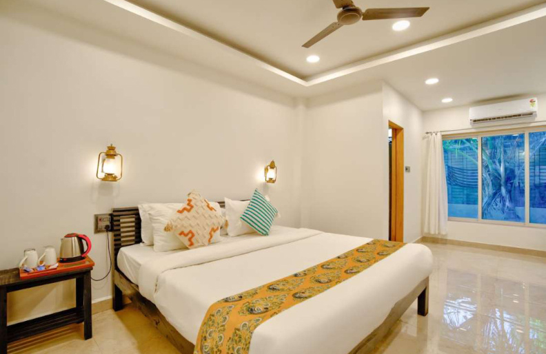 Modern AC bedroom with comfortable bed and lighting