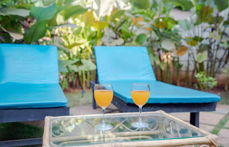 Garden lounge chairs with drinks in Morjim private pool villa