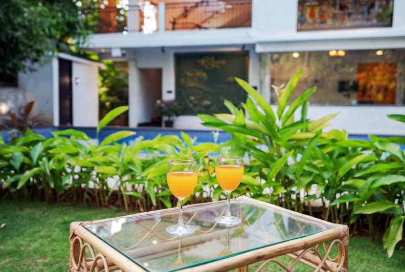 Poolside garden seating with drinks at Morjim luxury villa