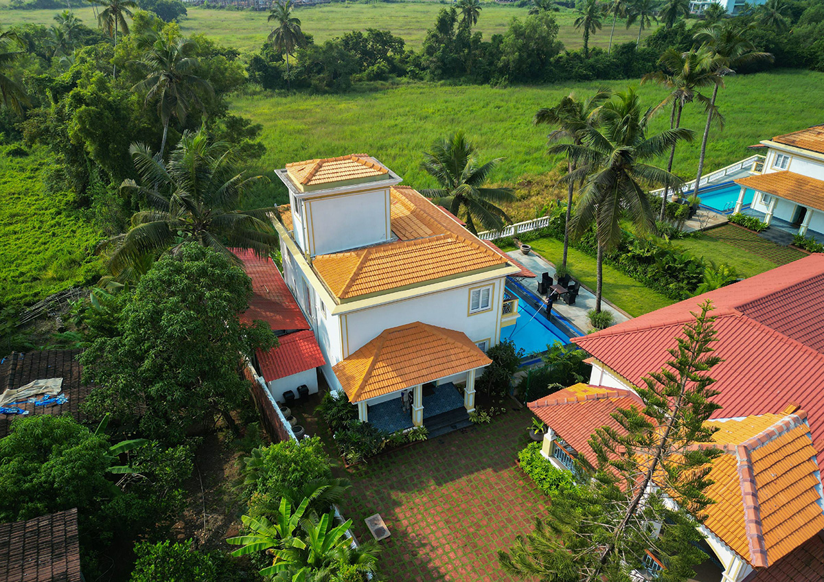 Aerial backyard view of a villa featuring a private pool and lush landscaping
