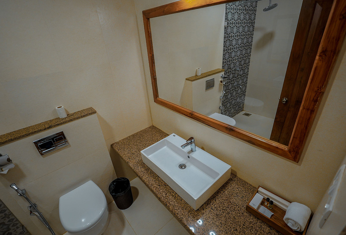 Elegant bathroom with large mirror, countertop and glass shower enclosure