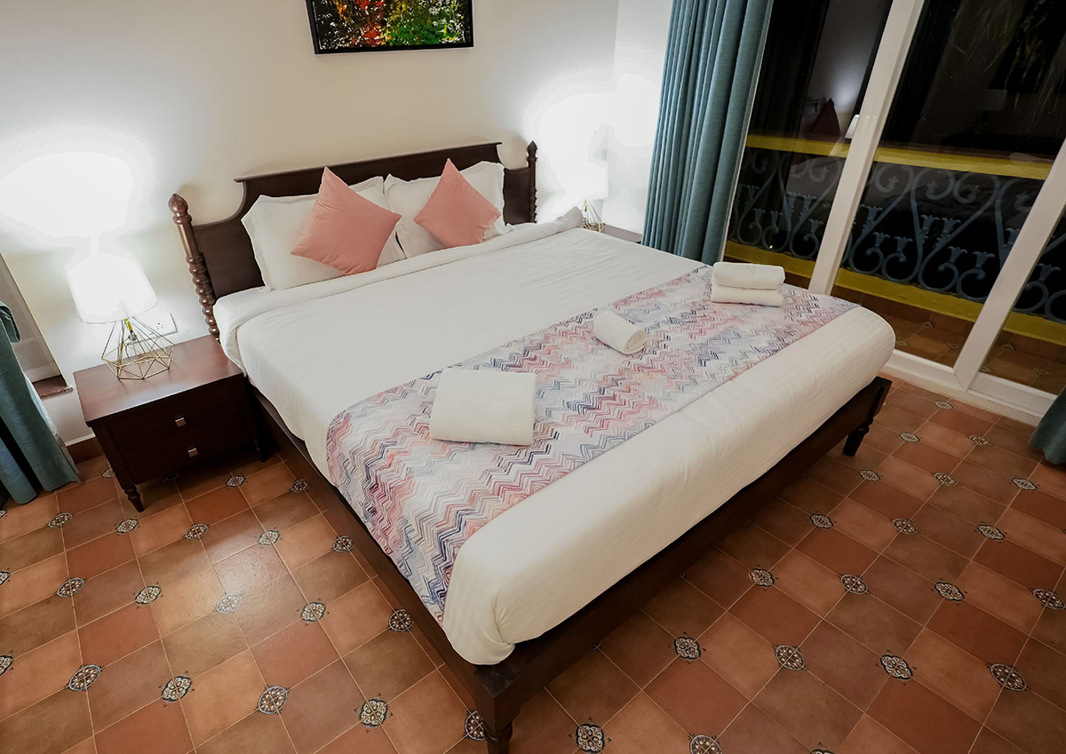 Elegant bedroom with polished wooden furniture and pastel accents