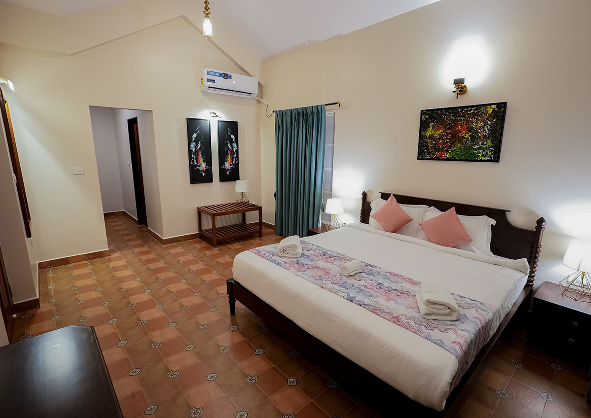 Bedroom with large bed, stylish decor, and natural lighting