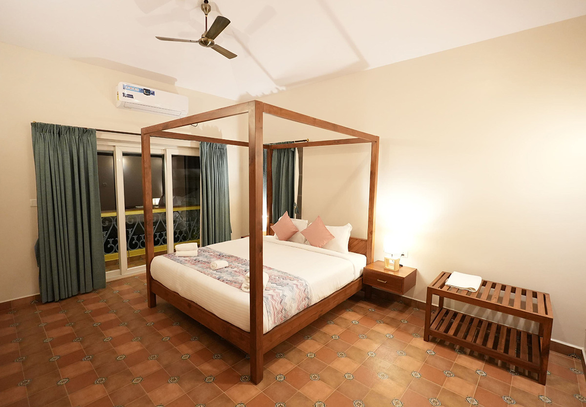 Spacious bedroom featuring a four-poster bed and elegant furnishings