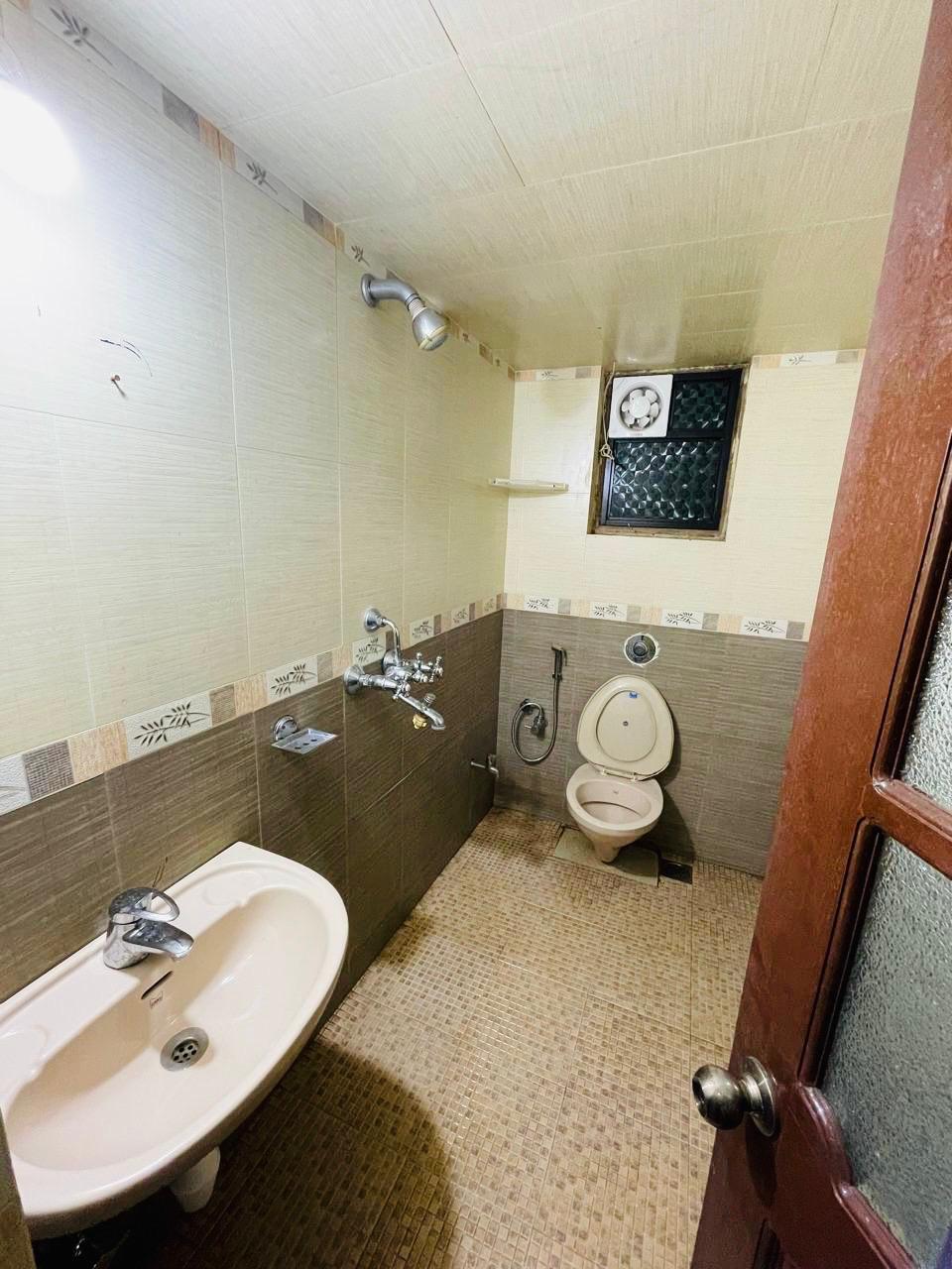Small bathroom with beige and brown tile