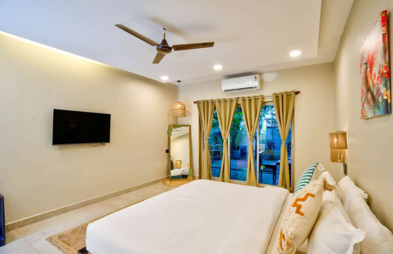 Luxury bedroom with balcony doors and garden view