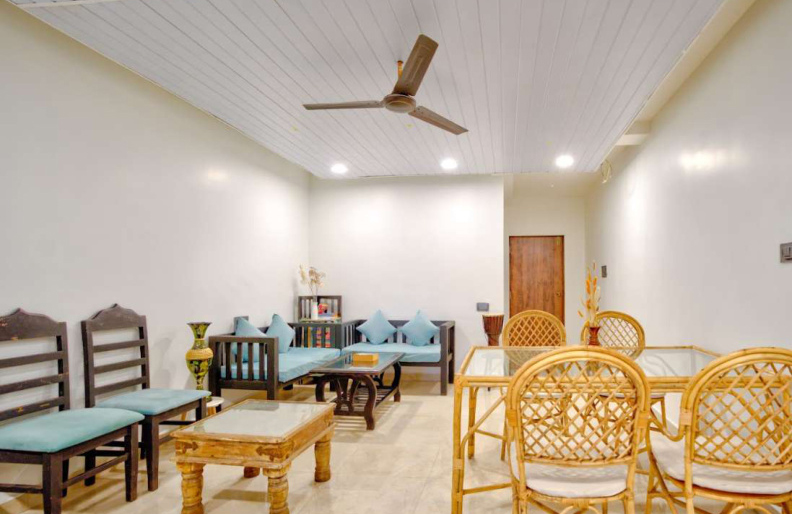 Spacious villa living room with sofa seating and indoor dining area