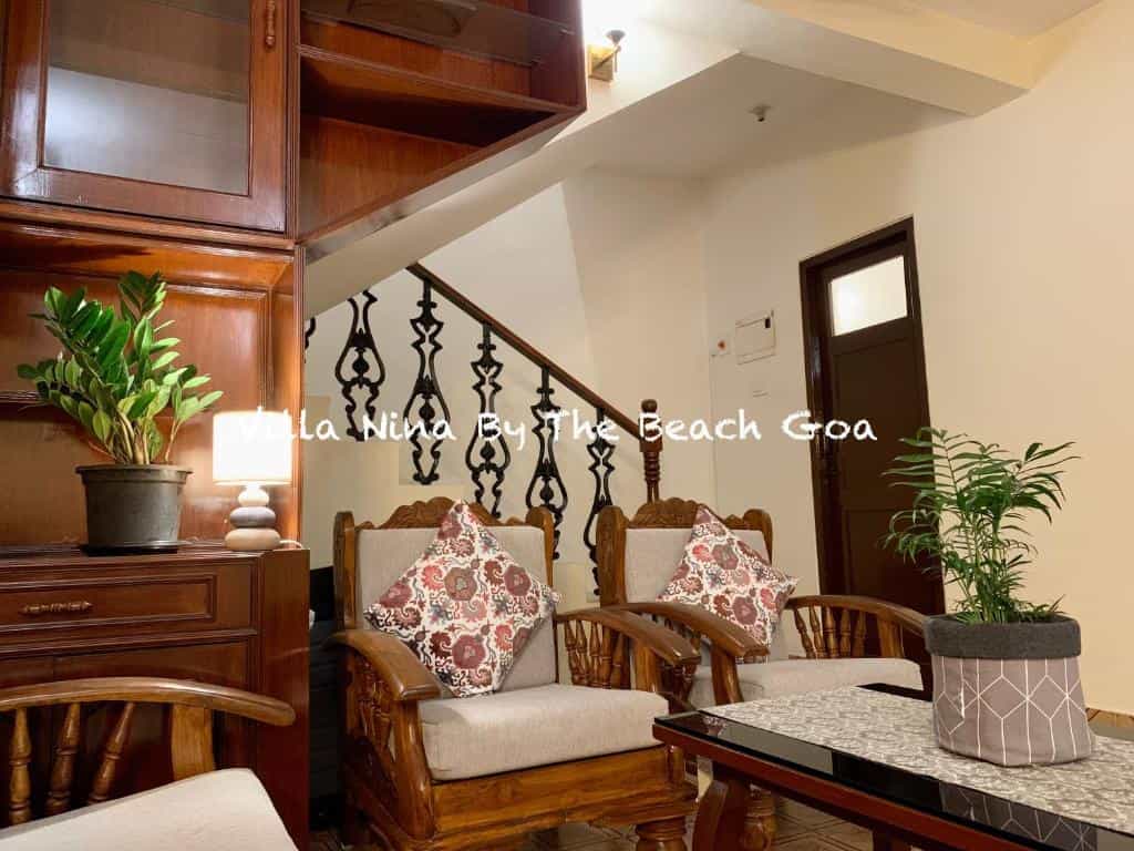 Villa living room with wooden chairs and staircase