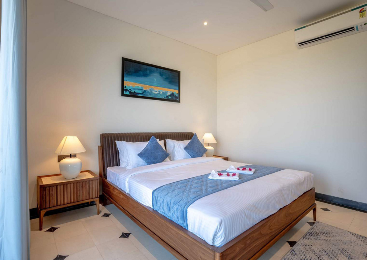 Bedroom with modern artwork, blue accents, and wooden furniture for a relaxed retreat feel