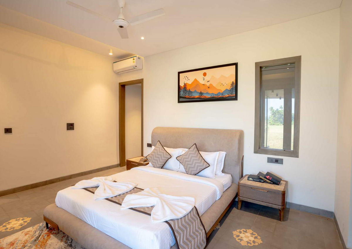 Beige-themed bedroom with soft lighting and minimalist decor