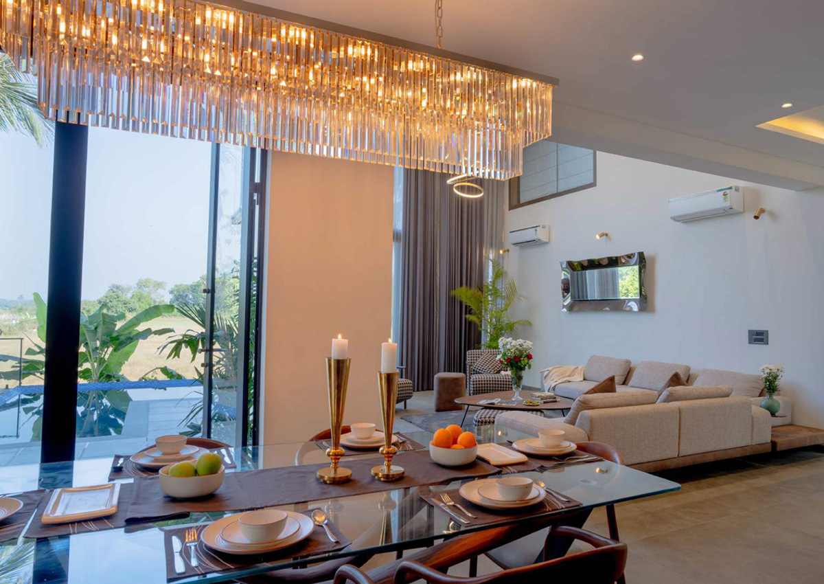 Elegant dining area with crystal chandelier and table setting