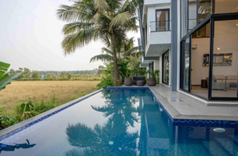 Infinity-style private pool villa with lush green surroundings.