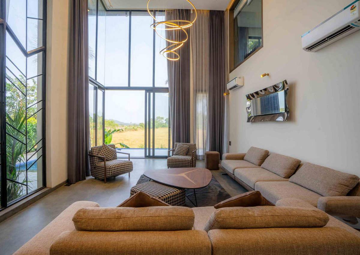 Modern double-height living room with panoramic glass walls and chic decor